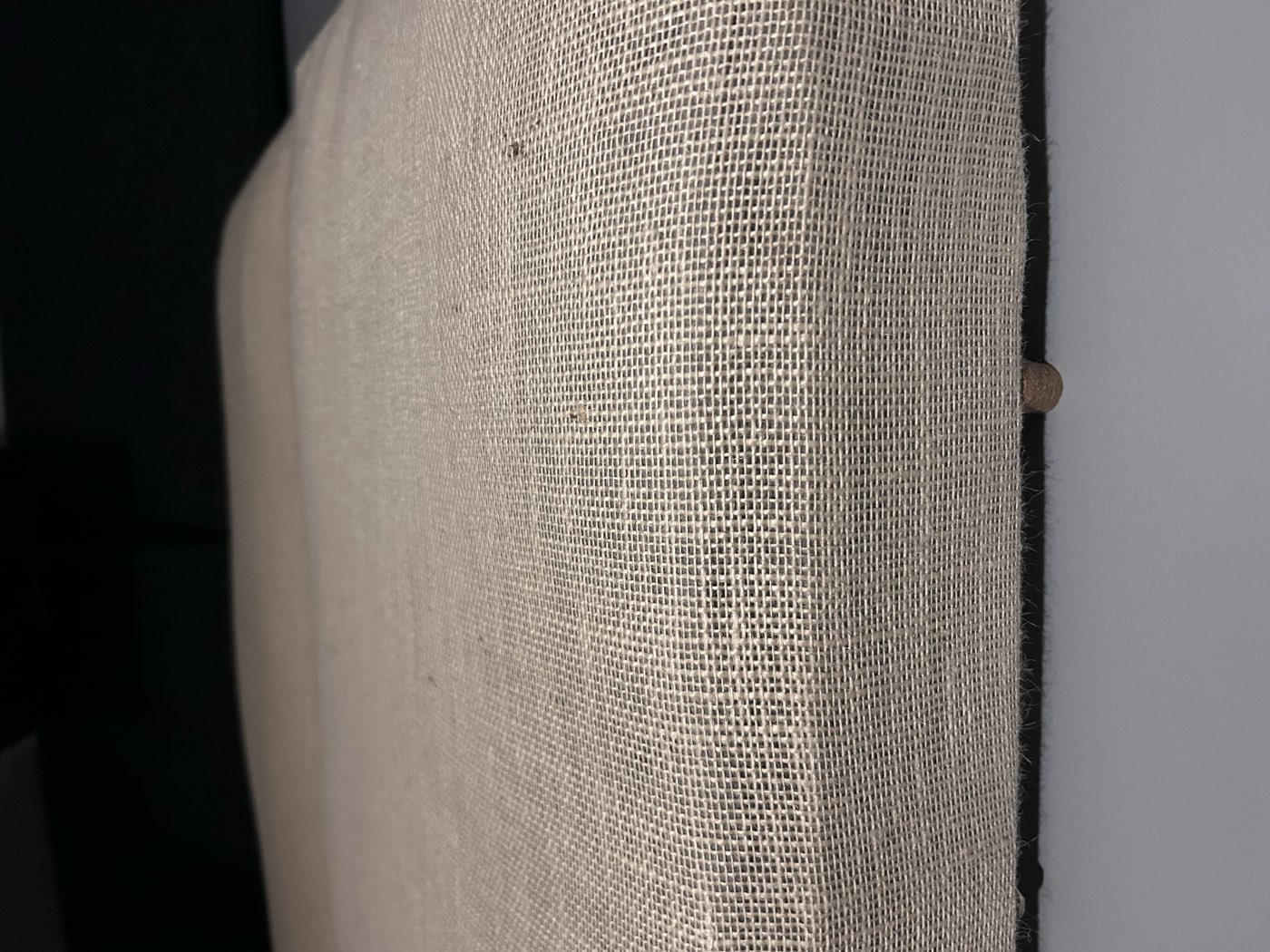 Close-up of the burlap weave on a hand-built acoustic panel